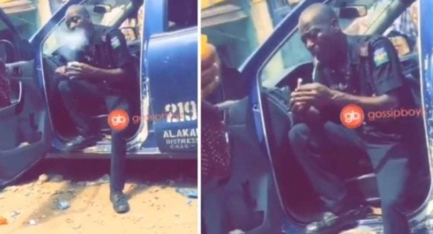 Nigerian Police Officer seen rolling up something that looks like Marijuana 1 Nigerian Police Officer seen rolling up something that looks like Marijuana 1
