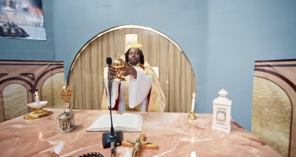 Dramatizing giving the Eucharist for a music video that has no connection with Christianity is disrespectful - Solomon Buchi slams Asake over new music video 7